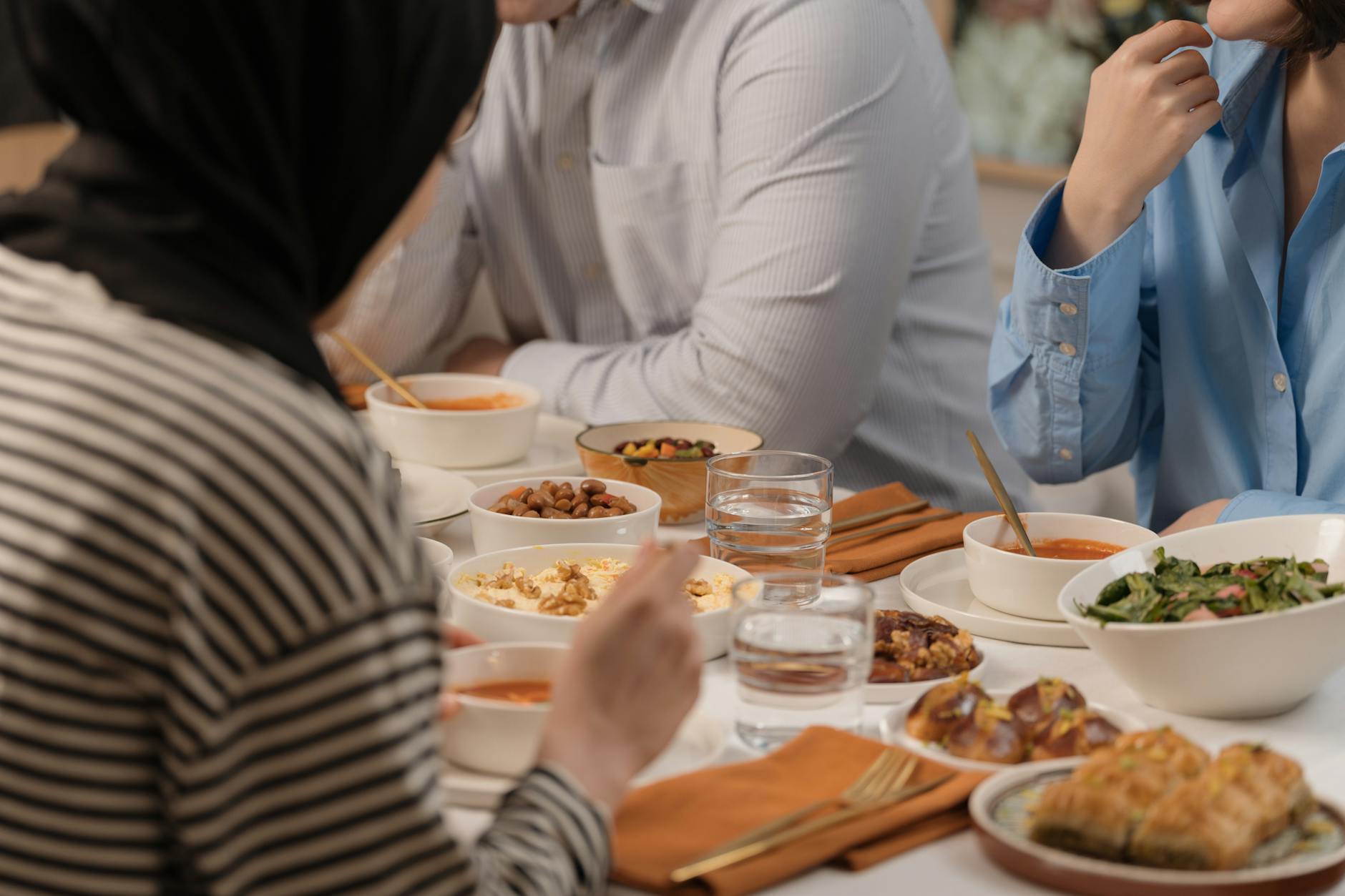 Friends sharing a healthy meal at a long table